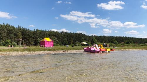 a group of boats in a body of water at Садиба For Rest in Svityazʼ