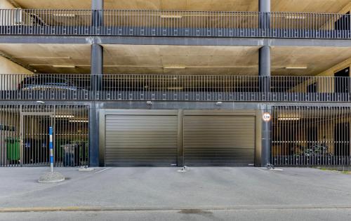 two garage doors on the side of a building at 15 korruse premium katusekorter in Tallinn
