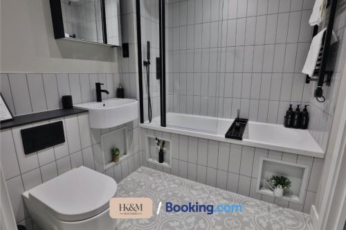 a bathroom with a toilet and a sink at NEAR WEMBLEY STADIUM, FREE PARKING, 5 MIN FROM BRENT CROSS WEST STATION, SLEEPS 7 By HKM HOUSING Short Lets & Serviced Accommodation Cricklewood & BRENT CROSS in London