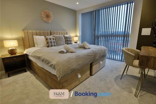 a bedroom with a bed and a desk and a window at NEAR WEMBLEY STADIUM, FREE PARKING, 5 MIN FROM BRENT CROSS WEST STATION, SLEEPS 7 By HKM HOUSING Short Lets & Serviced Accommodation Cricklewood & BRENT CROSS in London