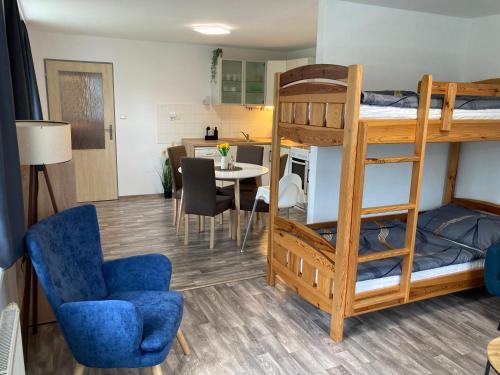 a room with a bunk bed and a dining room at Apartmán Lipno 1 in Lipno nad Vltavou