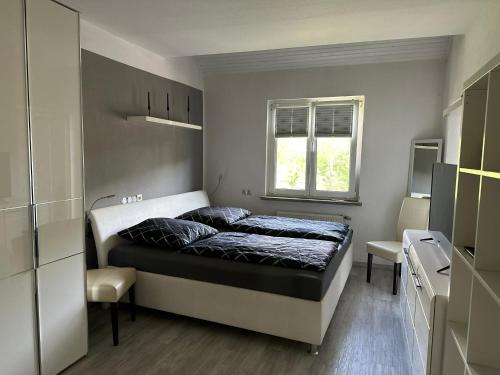 a small bedroom with a bed and a window at Ferienhaus Am Ettersberg in Ettersburg