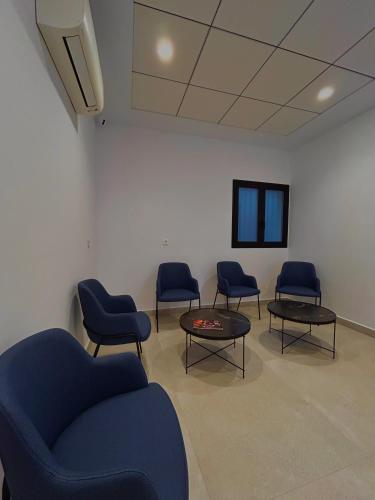 a waiting room with chairs and a couch and a table at Pensión La Orozca Benidorm in Benidorm