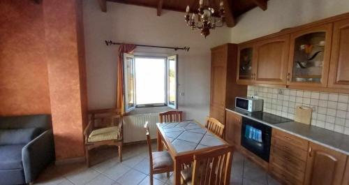 a kitchen with a table and a dining room at Kostantina's House Kythera in Kámbos