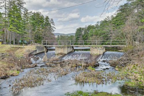 a bridge over a river with a waterfall at Lake and Beach Access at Lake Luzerne Cabin! in Lake Luzerne
