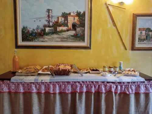 a table with bread and other food on it at Locanda D'Ogliastra, in Triei
