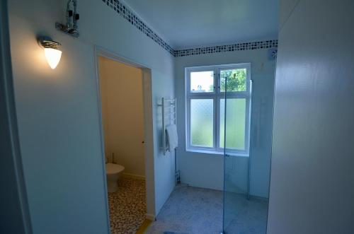 a bathroom with a shower and a toilet and a window at Husby Wärdshus in Dala Husby