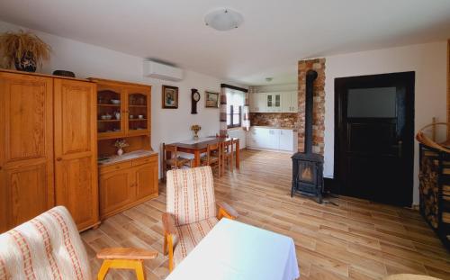a living room with a kitchen and a dining room at Chalupa Kocourov in Slavíkov