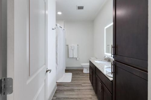 a white bathroom with a sink and a toilet at Luxe Living In Knoxville! Overlook At Farragut in Knoxville