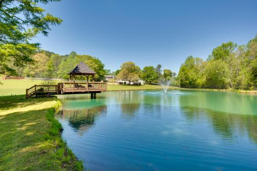a pond with a gazebo in the middle at Shared Game Room and Lake Access Hiram Apartment in Hiram