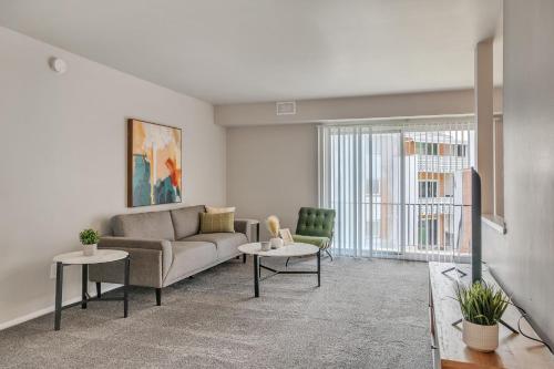 a living room with a couch and two chairs at Spacious Retreat I Balcony I Parking I Chateau in Wilmington