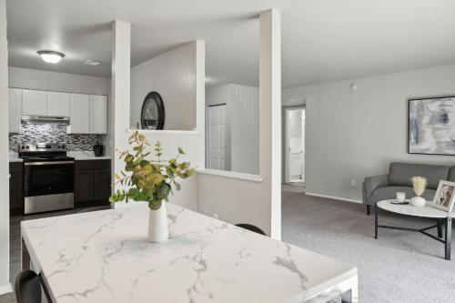 a kitchen and living room with a white marble table at Chateau 506 Stunning In Wilmington, Free Parking! in Wilmington