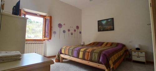 a bedroom with a bed and a window at A casa di Iole tra il Chianti e la bella Firenze in Florence