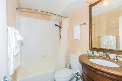 a bathroom with a sink and a toilet and a tub at Ilikai Marina 1383 City View Studio in Honolulu