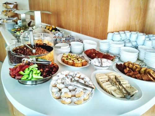 a buffet with many different types of food on a table at Aegean Blue Beach Hotel in Nea Kalikratia