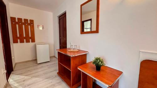 a room with a table and a mirror on a wall at Valea Albă View - SELF CHECK-IN in Buşteni
