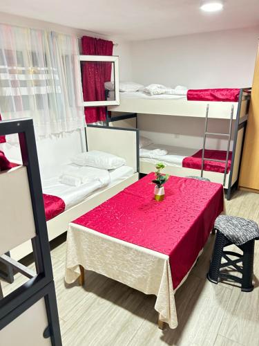 a room with a table and two bunk beds at Sneza in Podgorica