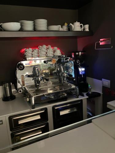 a kitchen with a coffee maker on top of a stove at B&B Morindino Design in Milan
