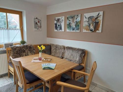 a dining room with a wooden table and chairs at Alpennest Comfortable holiday residence in Füssen