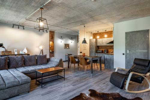 a living room with a couch and a table at Manto Loft style apartment in Klaipėda