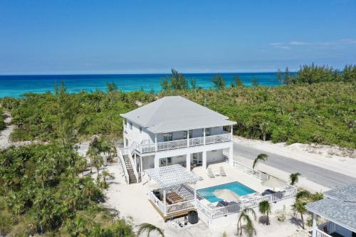 an aerial view of a house on the beach at The Better Life & Cottage home in Governorʼs Harbour