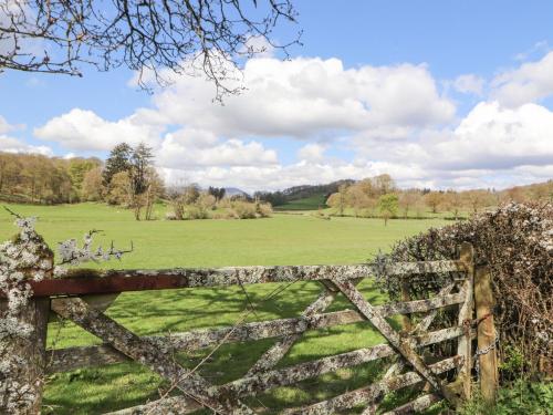 an old wooden gate with a field behind it at Bishop Howe in Far Sawrey