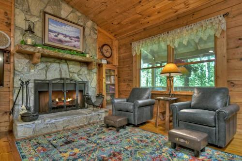 a living room with two chairs and a fireplace at Goldfinch Rustic - Retreat w Hot Tub& Fire Pit in Ellijay