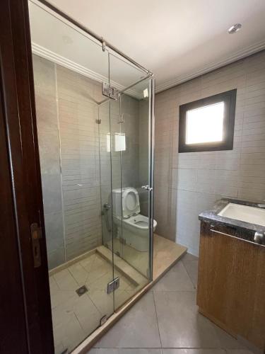 a bathroom with a glass shower with a toilet at Villa Aglou Center Near Mirlaft in Zaouia Sidi Ouaggag