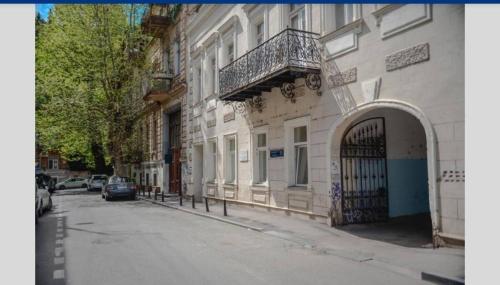 a building with a gate on the side of a street at Salve Rooms(tabidze) in Tbilisi City