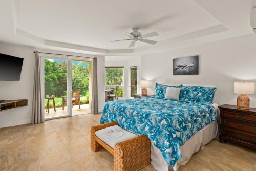 a bedroom with a bed with a blue bedspread at Stunning 3br 3ba Corner Unit Villa of Kamalii, AC, Pool, Hot Tub Unit 23 in Princeville