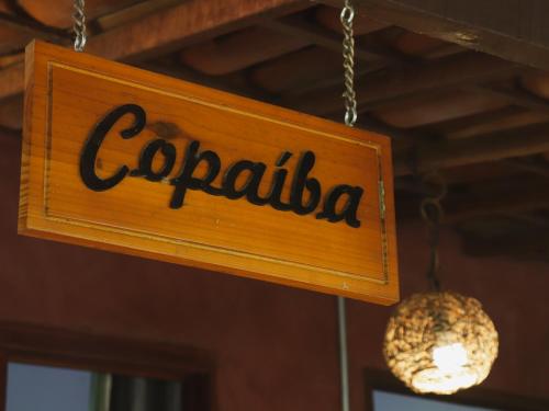 a sign that reads corrala hanging from a ceiling at Pousada Donalu - Ótima Localização in Vale do Capao