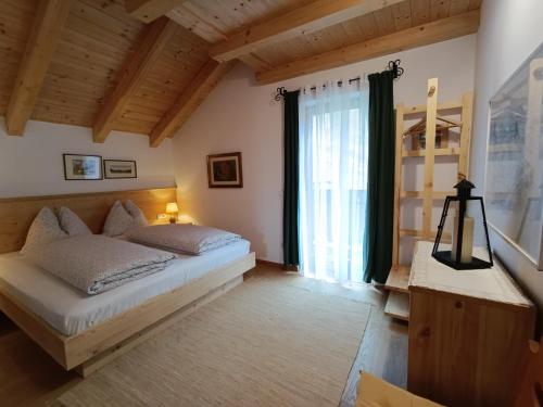 - une chambre avec un lit et une grande fenêtre dans l'établissement Masches-chalet, à Funes