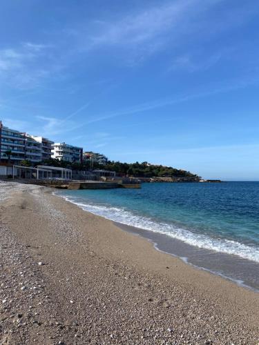a beach with the ocean and buildings in the background at Sunrise apartmani in Bar
