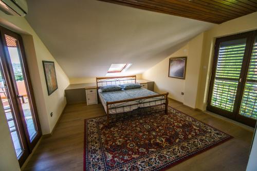 a bedroom with a bed and a rug at Apartments Sara in Portorož