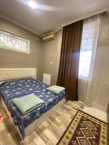 a bedroom with a bed and a window at Anna'S Home in Kutaisi