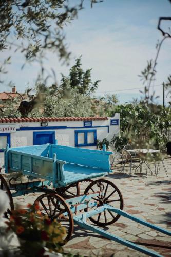 a blue horse drawn carriage in front of a building at Resort Dimitris in Alexandroupoli