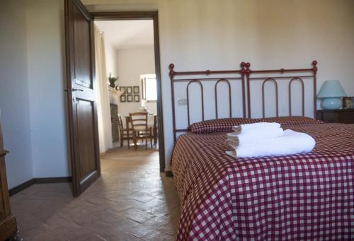 a bedroom with a bed with towels on it at Agriturismo Piano Grande in Avigliano