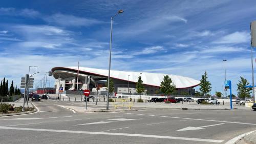 a large building with a white roof and a parking lot at Madrid Encanto , Barajas , Aeropuerto, IFEMA in Madrid