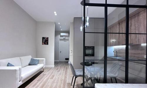 a living room with a white couch and a table at Pearbow Apartment 232 in Hallignicourt