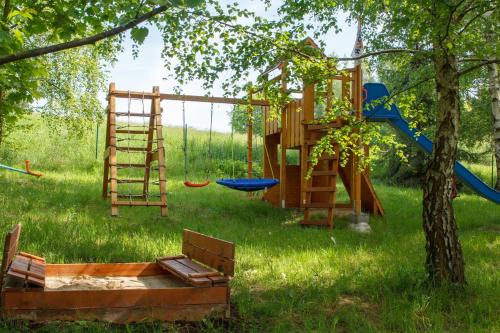 a playground with a ladder and a swing at Noclegi Bajama in Siepraw