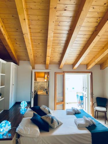 two beds in a room with a wooden ceiling at Sweet Dream House in Carloforte