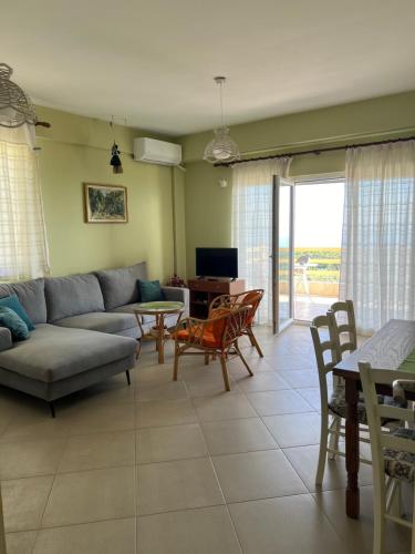 a living room with a couch and a table and chairs at Vila Aleks in Vuno