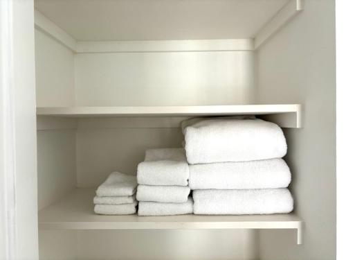 a pile of towels in a white closet at Ilikai Apt 1822 - Newly Renovated 2BR 2BA Modern Unit with Stunning Ocean & Harbor Views in Honolulu