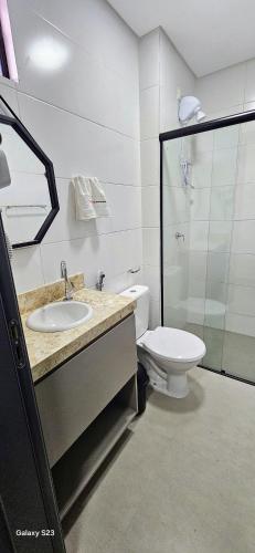 a bathroom with a sink and a toilet at Flats Tramonto - By EasyHost in João Pessoa
