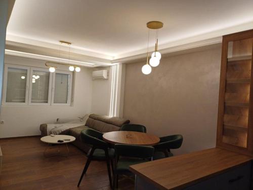 a living room with a couch and a table at Mila apartman in Prokuplje