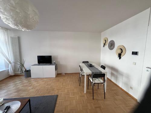 a white room with a table and chairs in it at Waldshut -Kaiser55 in Waldshut-Tiengen