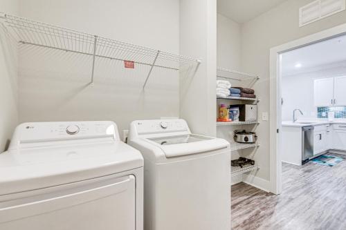 a white laundry room with a washer and dryer at Gorgeous Calabash Condo with Balcony and Pool Access! in Calabash
