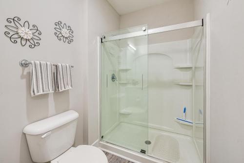 a bathroom with a shower and a toilet at Gorgeous Calabash Condo with Balcony and Pool Access! in Calabash