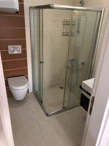 a bathroom with a shower and a toilet at Pine Golf Village Belek in Belek