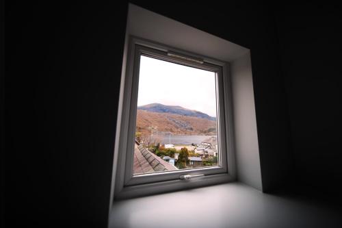 a window in a room with a view at Lake view townhouse in Llanberis